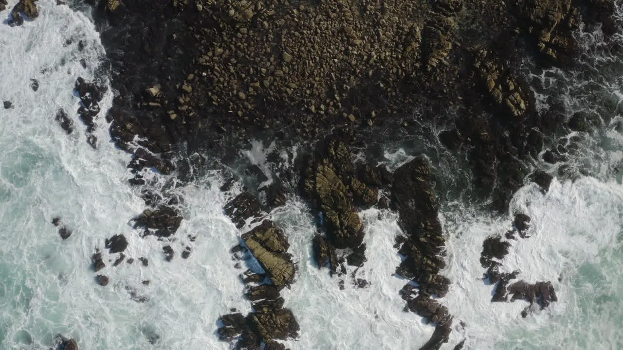 4K cinematic overhead corkscrew of big waves crashing on the California Coastline