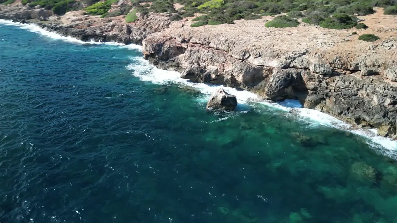 Scenic Waves Crashing On The Rocks On The Rugged Shoreline Near Sa Coma In Mallorca Spain