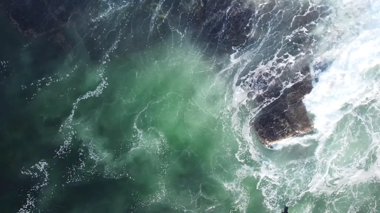 Drone pan aerial videography shot of bodyboarder jump rock off in ocean reef waves Central Coast NSW Australia 3840x2160 4K