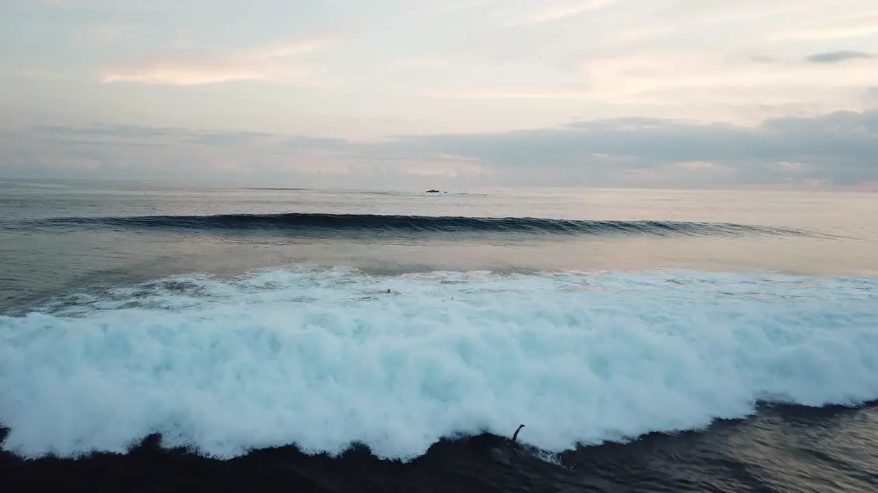 AERIAL 4K Waves Crashing Down Over Surfers in Water Lombok Indonesia