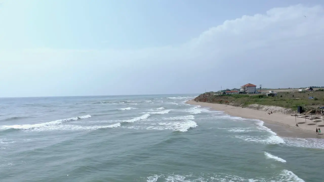 Flight Over Ocean With Foamy Waves In Vama Veche Romania drone shot