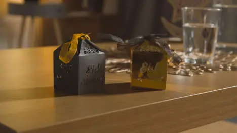 Close Up Of Gift Boxes On Table In Muslim Home Celebrating Eid 2