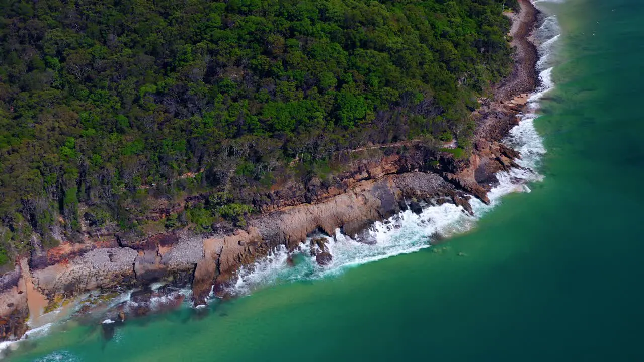 Tropical Ocean Waves Crashing Onto Rocks On The Noosa Heads In Queensland Australia aerial drone shot