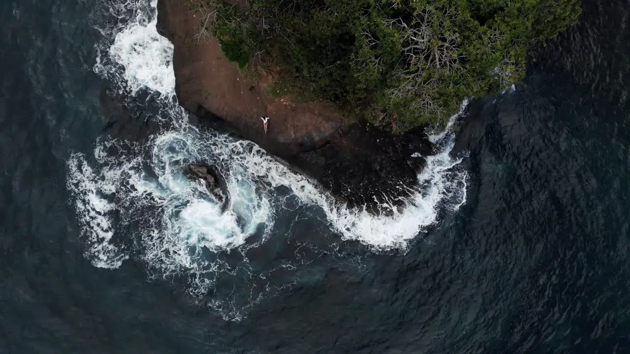 Strong sea waves splashing and crashing on the rocky green shoreline of Costa Rica top view