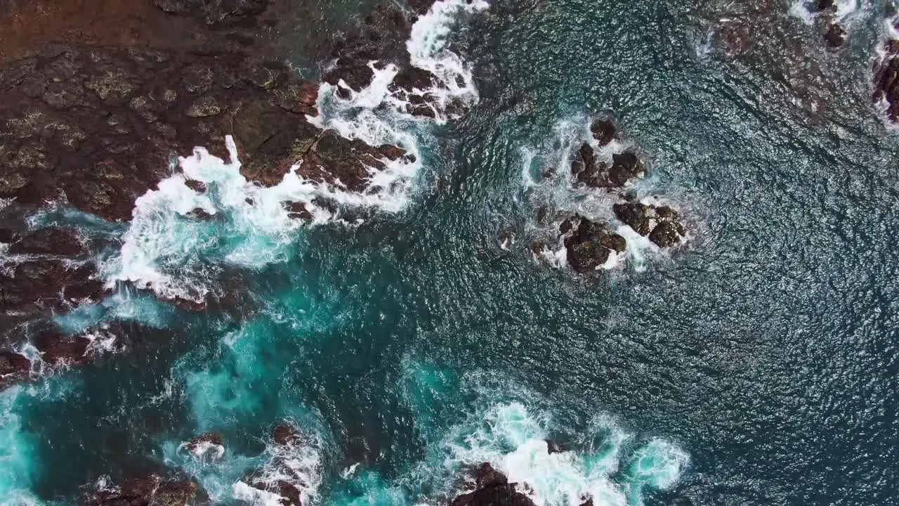 Beautiful Turquoise Blue Ocean Water With White Waves Crashing Into Rocky Coast