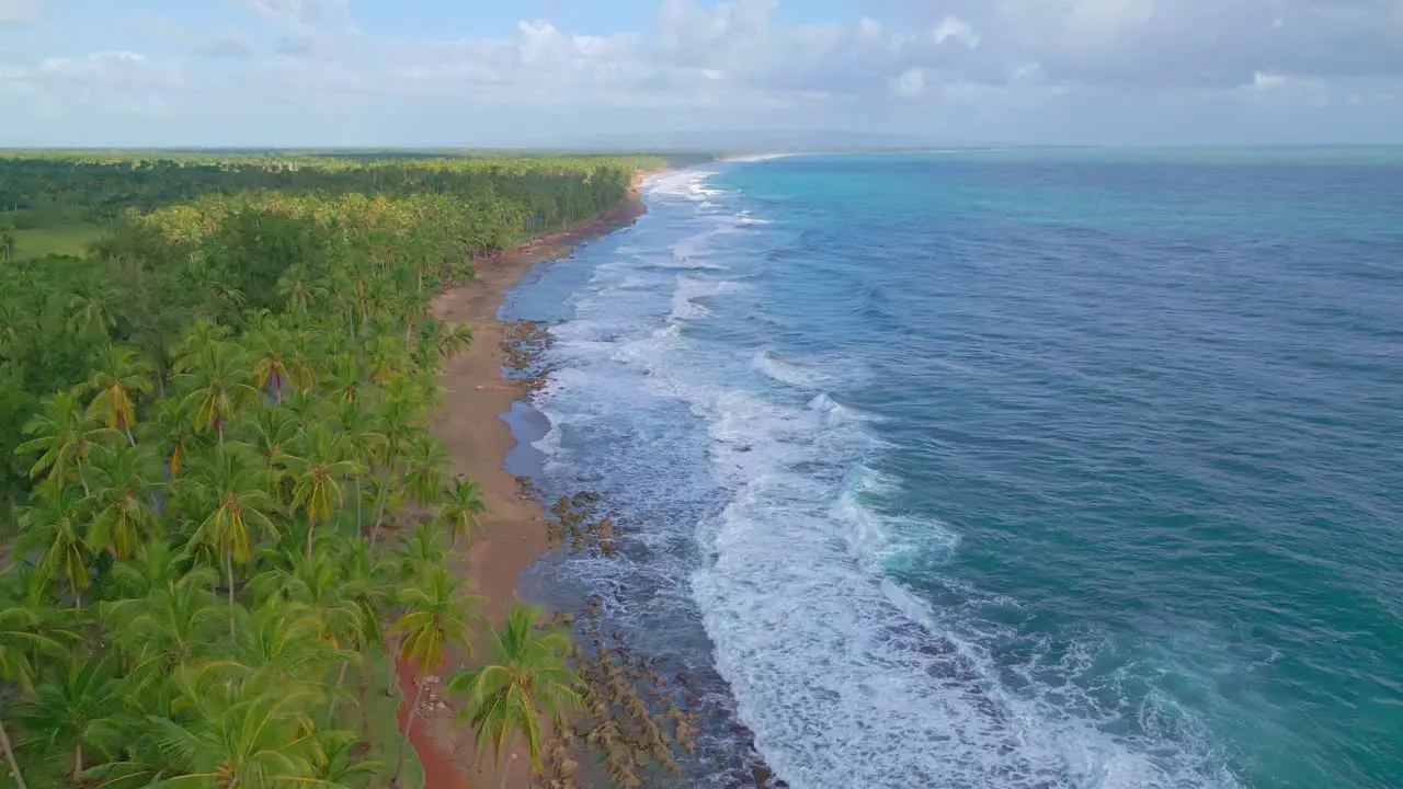 Foamy Waves Splashing On Sandy Shore Of Tropical Beach In Nagua Dominican Republic aerial drone shot