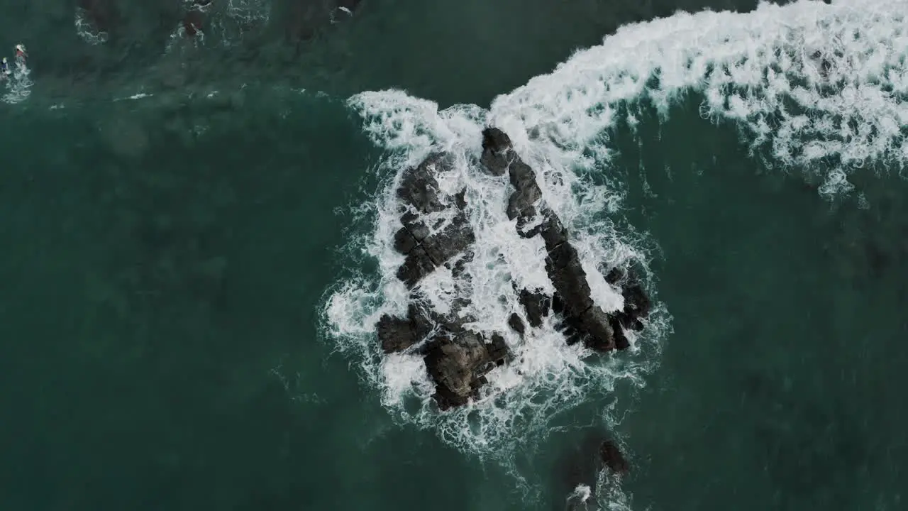 Foamy Waves Splashing On Ocean Rocks At Puerto Escondido Oaxaca Mexico aerial top down