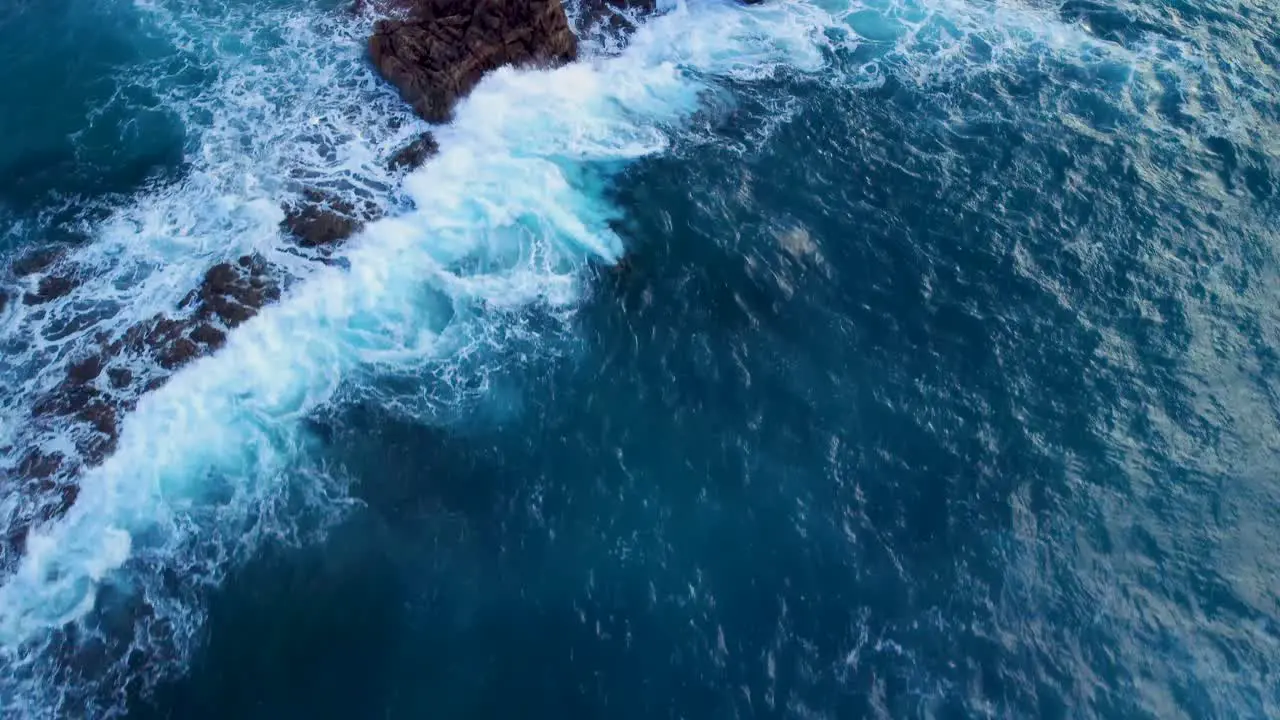 Waves With Foam Splashing On Rocky Coast In Arteixo Spain aerial drone shot