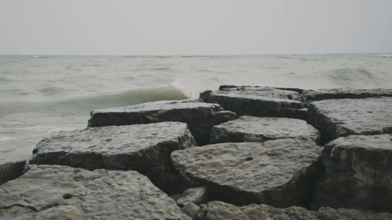 Sea Waves Crash On The Breakwater Rocks And Stones During Daytime