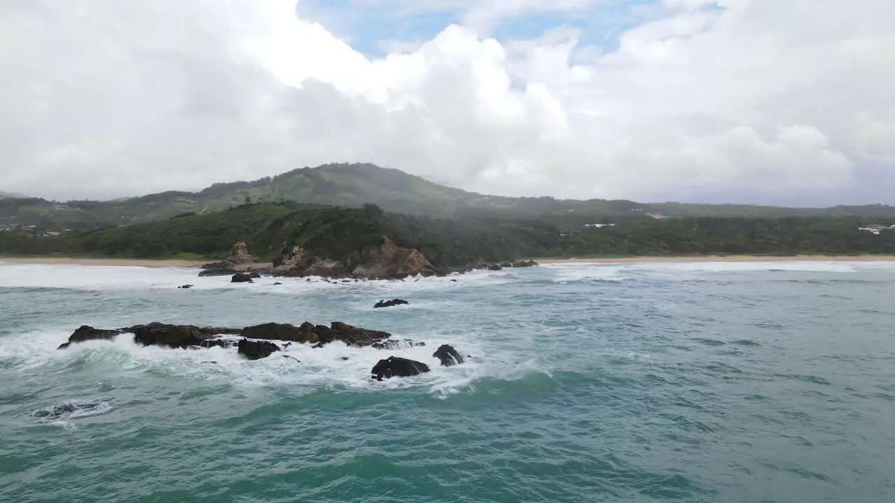 Ocean Waves Splashing On Rocky Outcrops Near The Shore