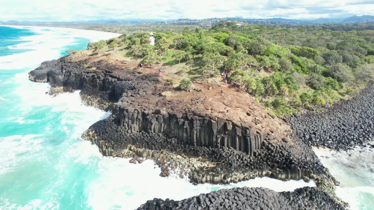 Man Waves At Drone Camera Flying Away From Fingal Headland In New South Wales Australia