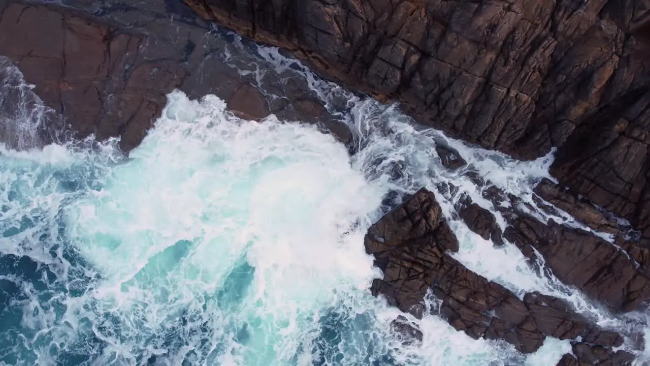 Ocean Waves Hitting Rocky Cliffs In Arteixo Spain aerial orbit