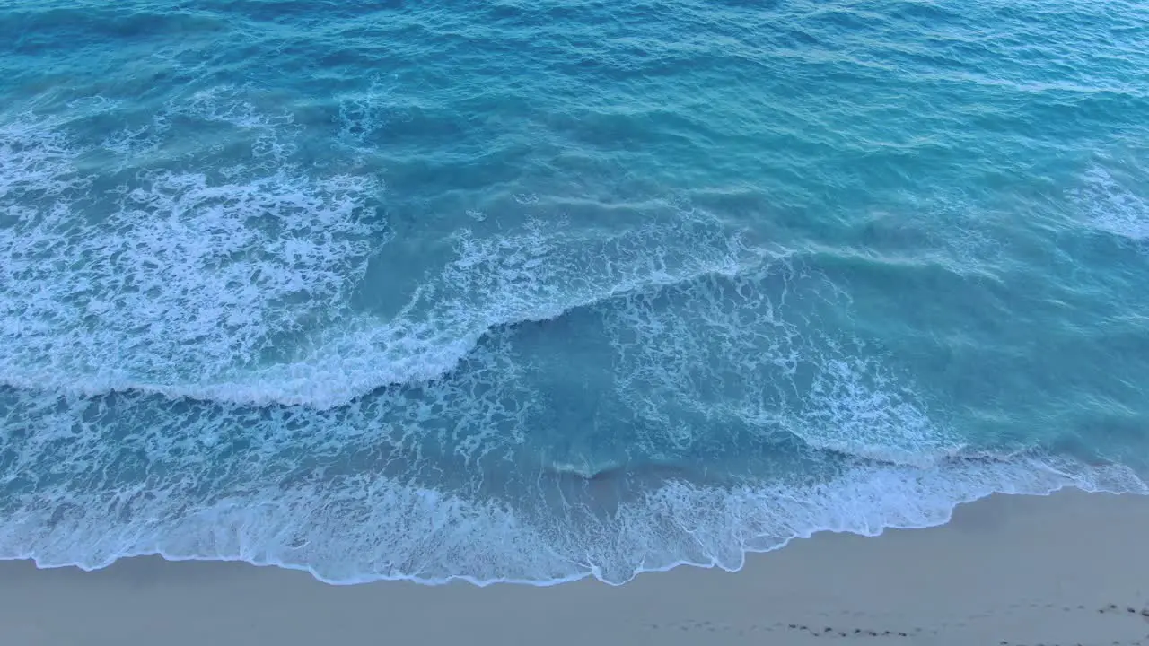 Descending Aerial Shot With Pan Up Revealing The Rest Of The Ocean