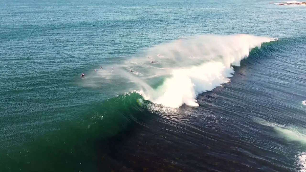 Drone pan shot of surfer stack wave fall on reef in Pacific Ocean Central Coast NSW Australia 3840x2160 4K