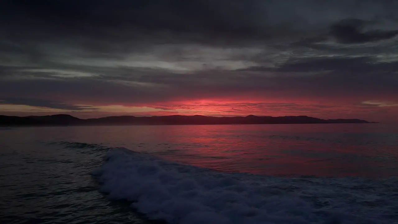 Dramatic Sunset Sky And Ocean Waves In Spirits Bay New Zealand drone static