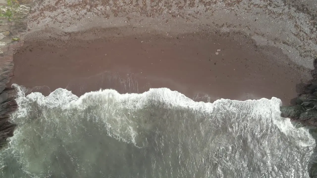 Ocean Waves Splashing On Sandy Shore Of The Beach In Ballycotton County Cork Ireland aerial top down