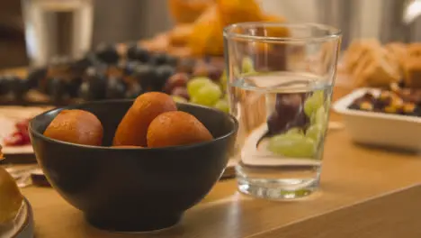 Close Up Of Food On Muslim Family Table In Home Set For Meal Celebrating Eid 12