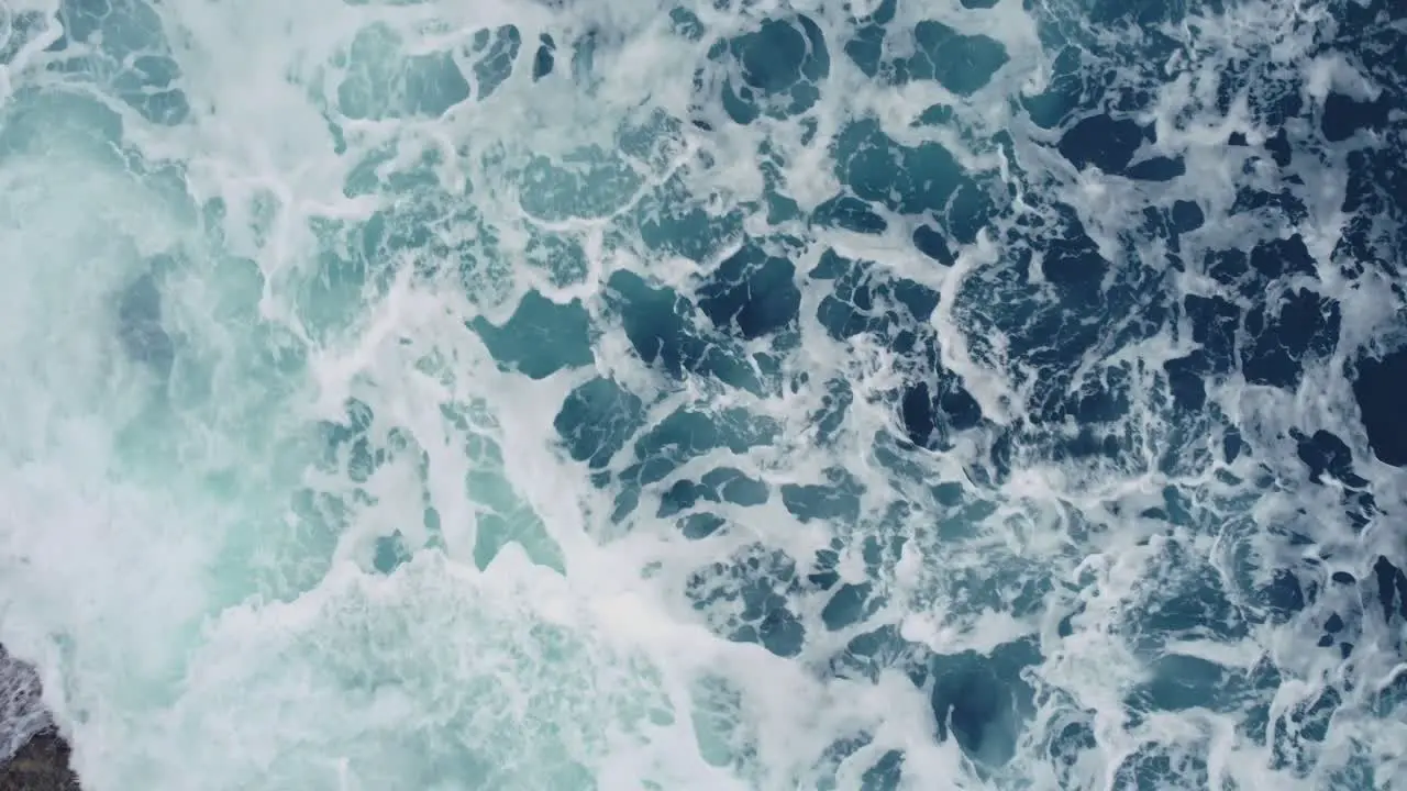 Turquoise Seascape With Foamy Waves In Arteixo Spain aerial top down