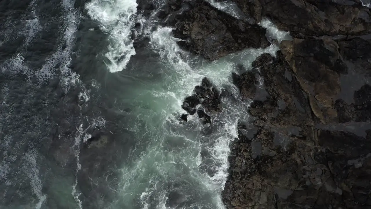 Tidal Foamy Waves Breaking On The Rocks