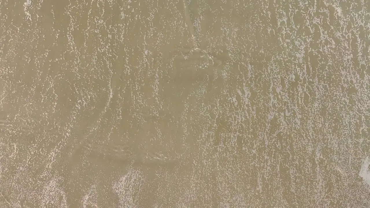 Foamy Ocean Waves Washing Sand Of Tropical Beach Top Down View