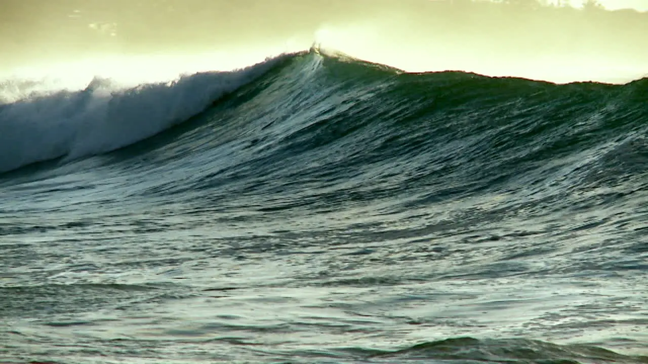 A photographer follows large waves as they crest and break in slow motion 1