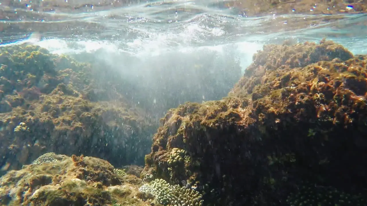 Waves Breaking On The Rocks Underwater