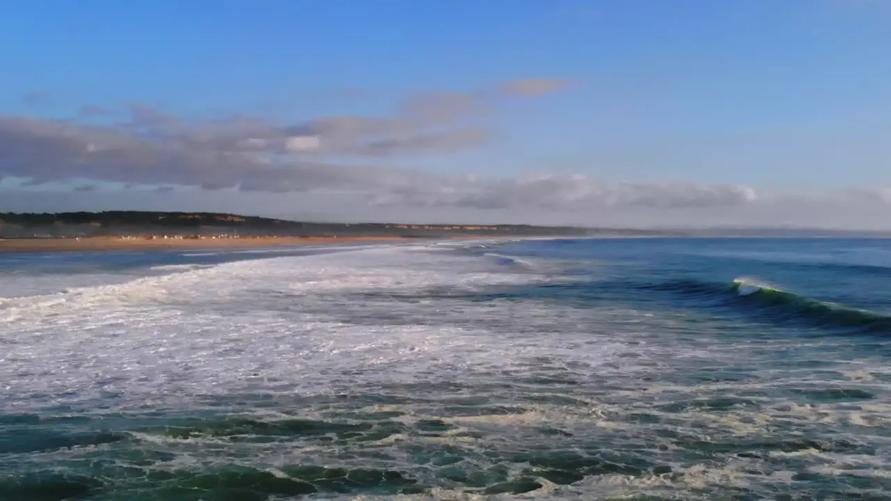 Drone footage of some waves rolling in by the beach