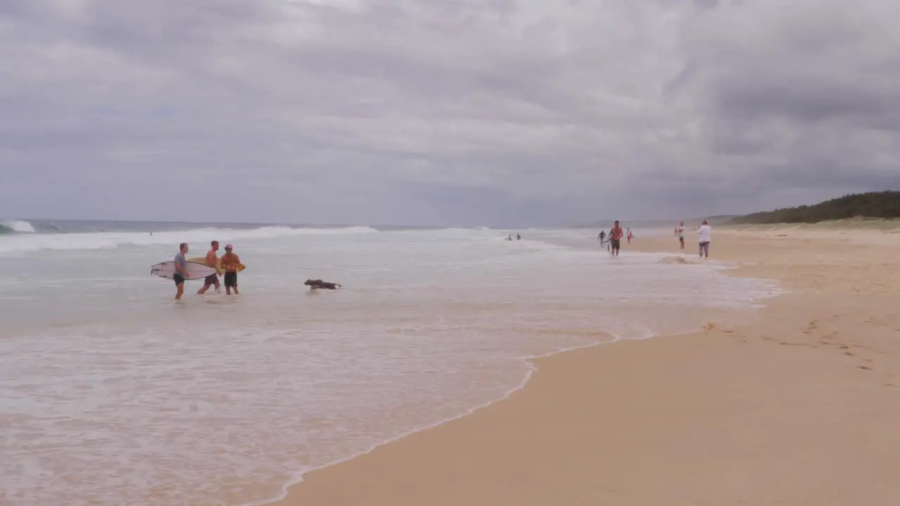 People On Splashing Sea Waves Of South Gorge Beach In Point Lookout North Stradbroke Island Queensland Australia