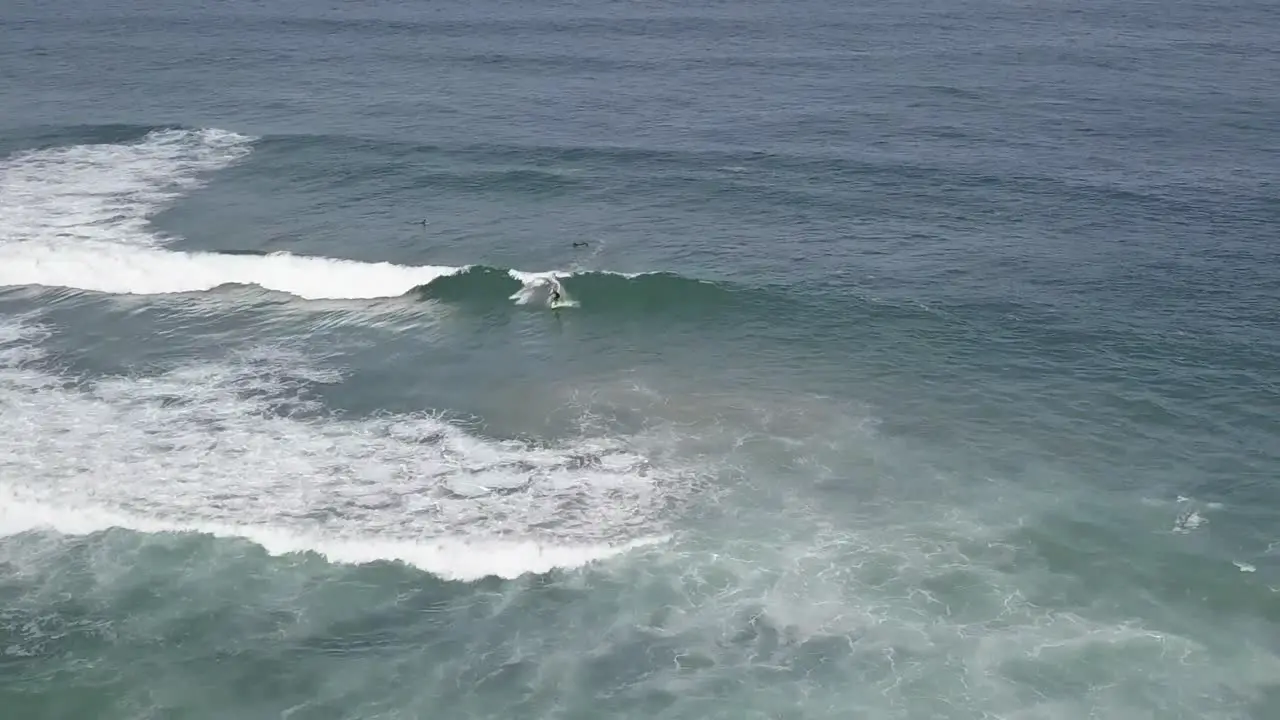 Man surfer surfing perfect ocean waves drone aerial shot