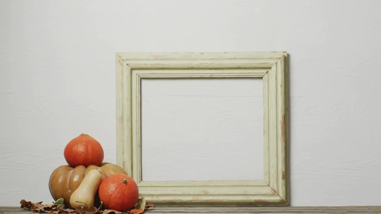 Video of pumpkins with autumn leaves and frame with copy space on white background