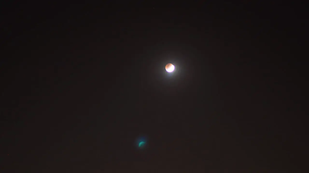 Blood moon rising and transition time lapse with shooting stars in the dark red sky background