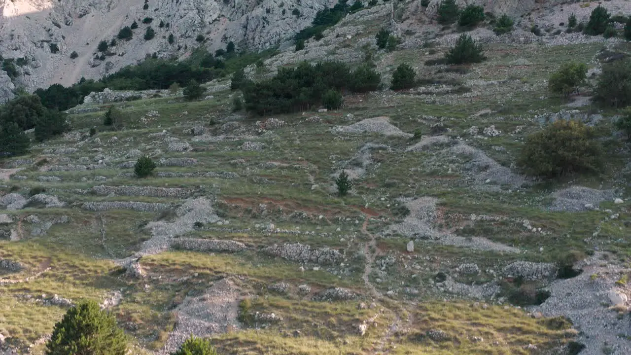 Stunning Nature Scenery At The Top Of A Mountain Popularly Known As The Moon Plateau In The Island Of Krk In Croatia Dry Stone Wall In The Background ascending drone shot