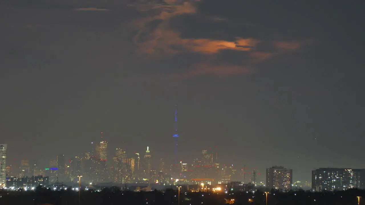 Time lapse of giant moon rising over Mississauga Toronto Canada wide shot