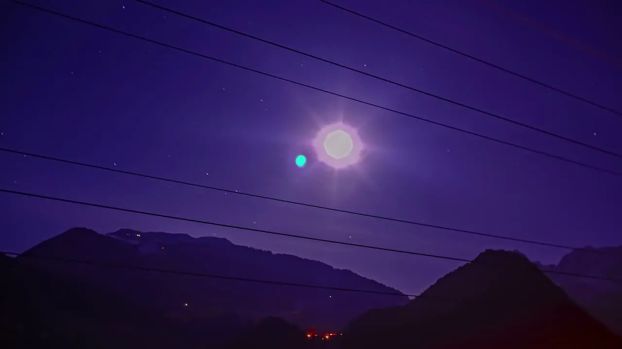 Shot of moon illuminates over the valley along