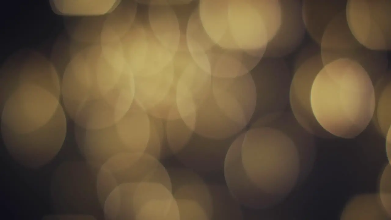 Video of bokeh yellow lights with copy space on dark background