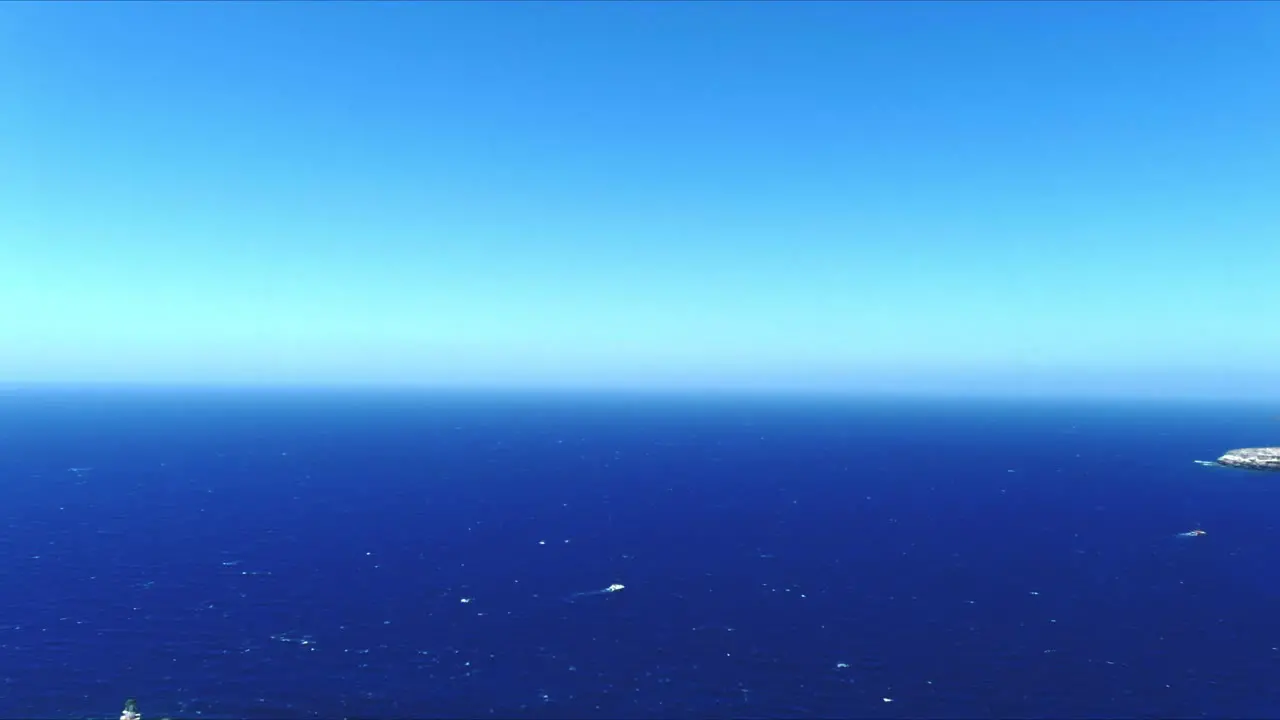 Aerial 4K Blue Sea and Sky Top View Over Akrotiri Lighthouse in Santorini Greece