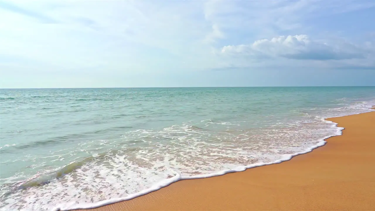 Empty Pristine Sandy Beach and Turquoise Sea Waves with Endless Skyline Static Slow Motion