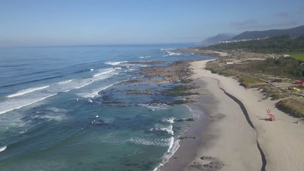 Aerial View Directly Above Gentle Ocean Waves Breaking onto Sand at Afife Portugal