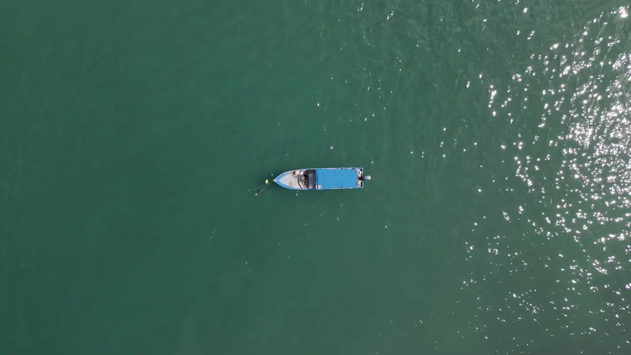 Static Top Down Shot Of A Fishermans Boat Anchored In The Ocean