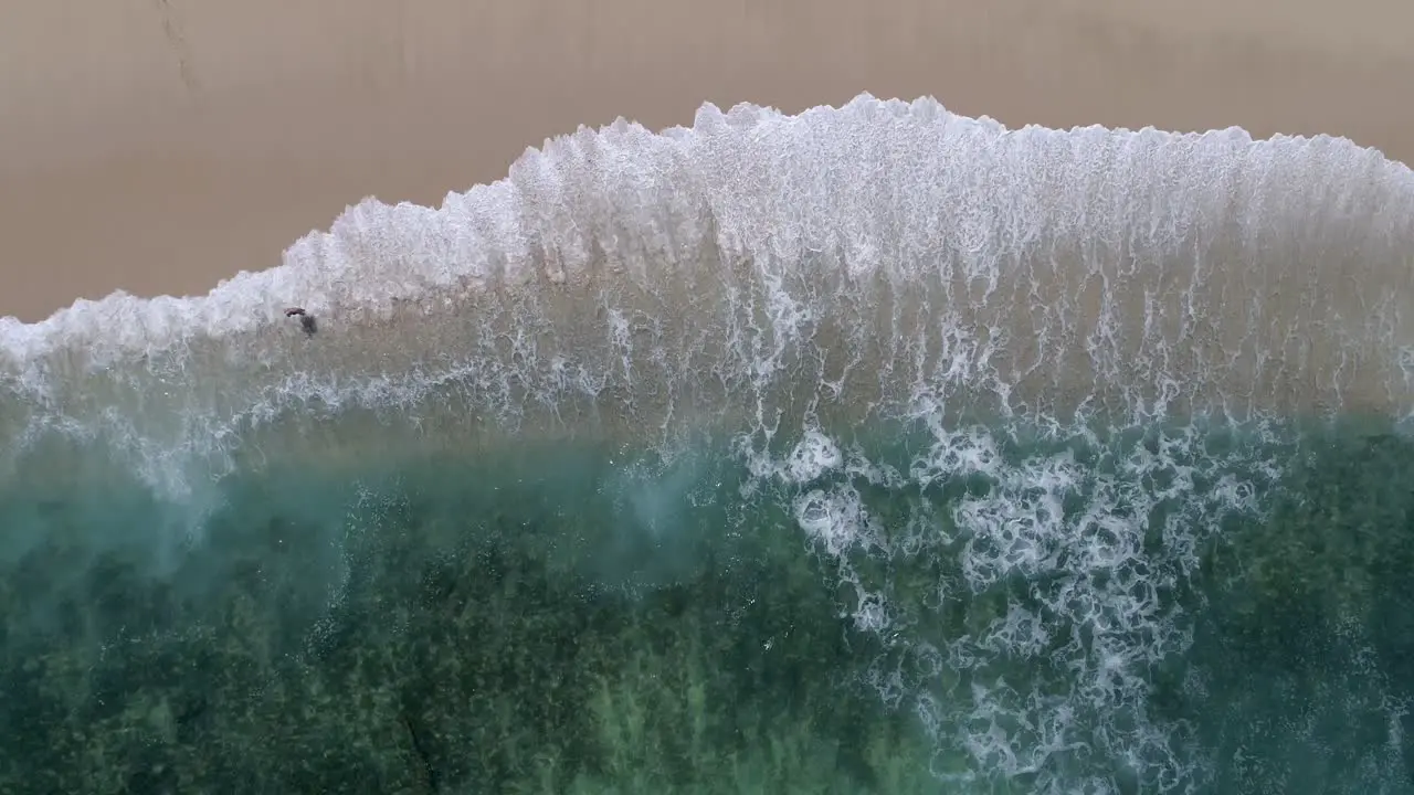 drone aerial waves crashing footage white sand beach and blue water