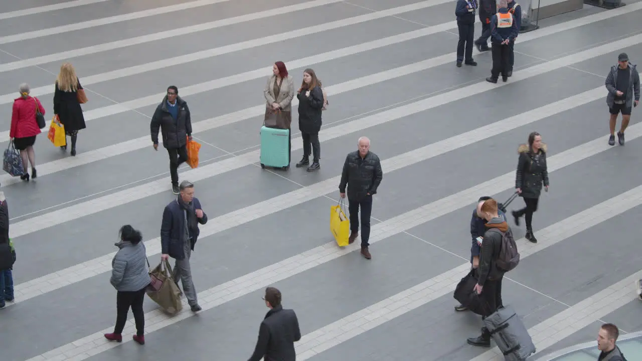 Commuters walking through train station