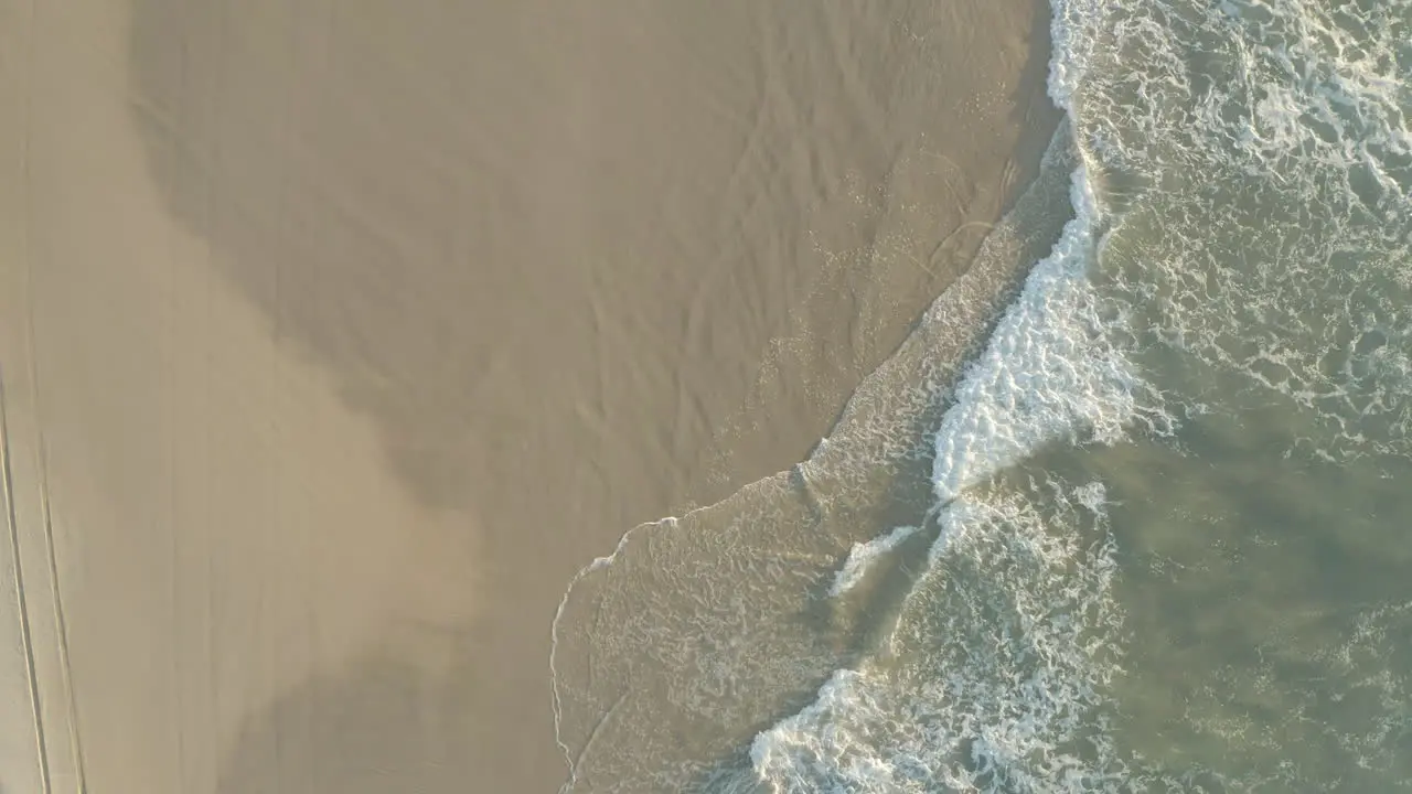 Top view of a beach shore with white sand and blue water waves on the beautiful island Fraser Island Australia