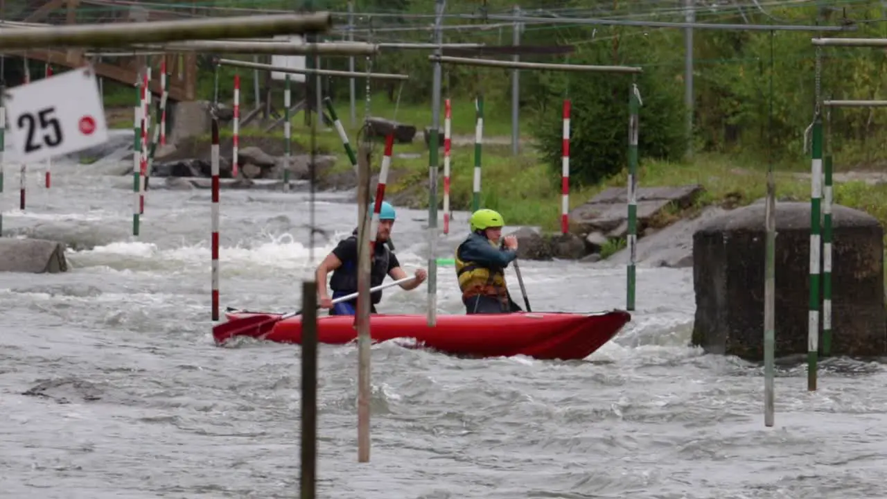 Slow motion shot of white water kayakers on a training course Slovakia