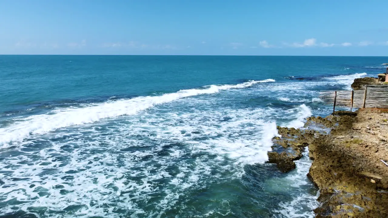 Waves crashing into rocks on the coast of St