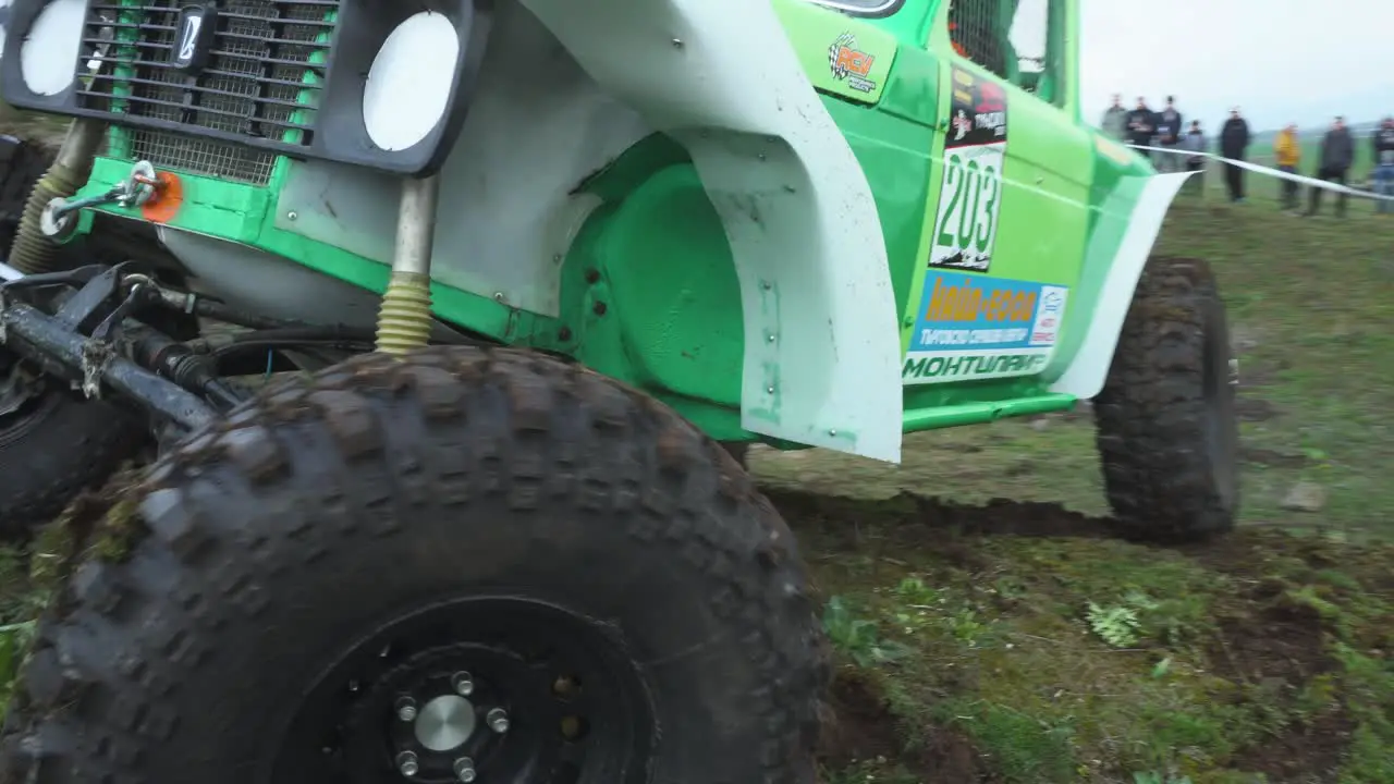 Modified off road 4x4 vehicle manoeuvre over steep hill in a competition