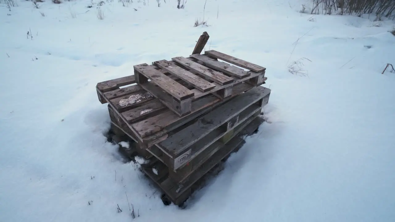 Pile of old wooden pallets left on a field