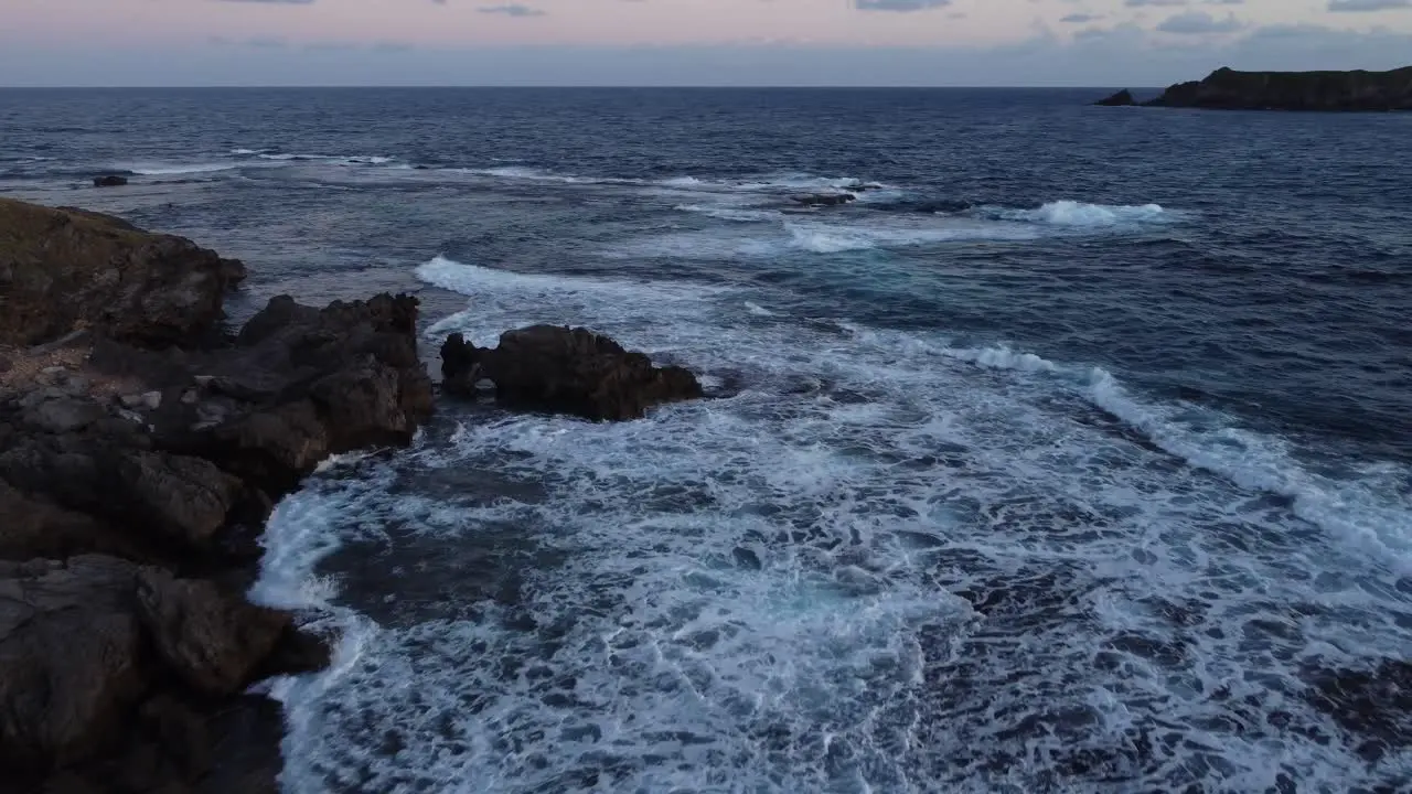 Aerial FPV fly over ocean full wave crash shore sunset