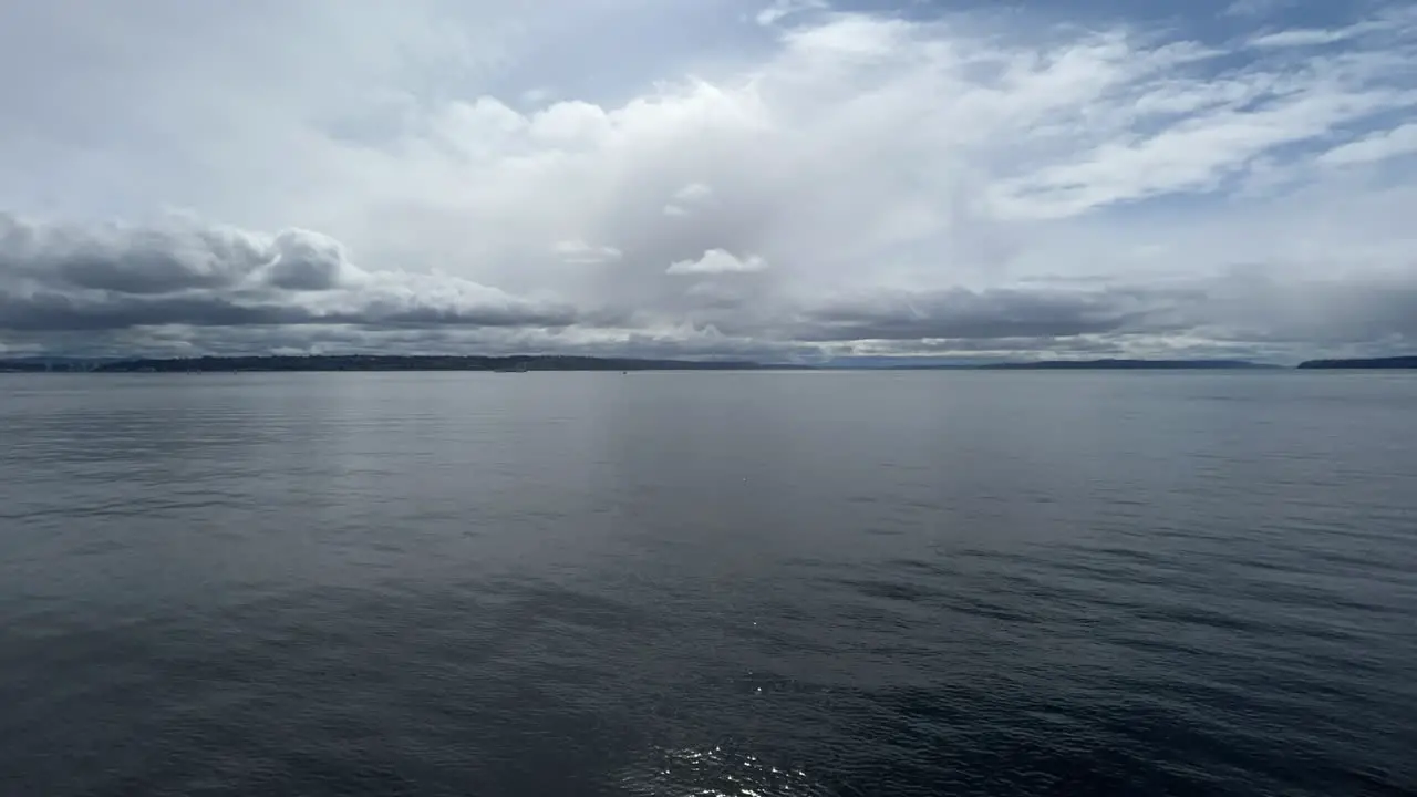 Blue sea water moving quickly beneath dramatic cloudy sky hyperlapse