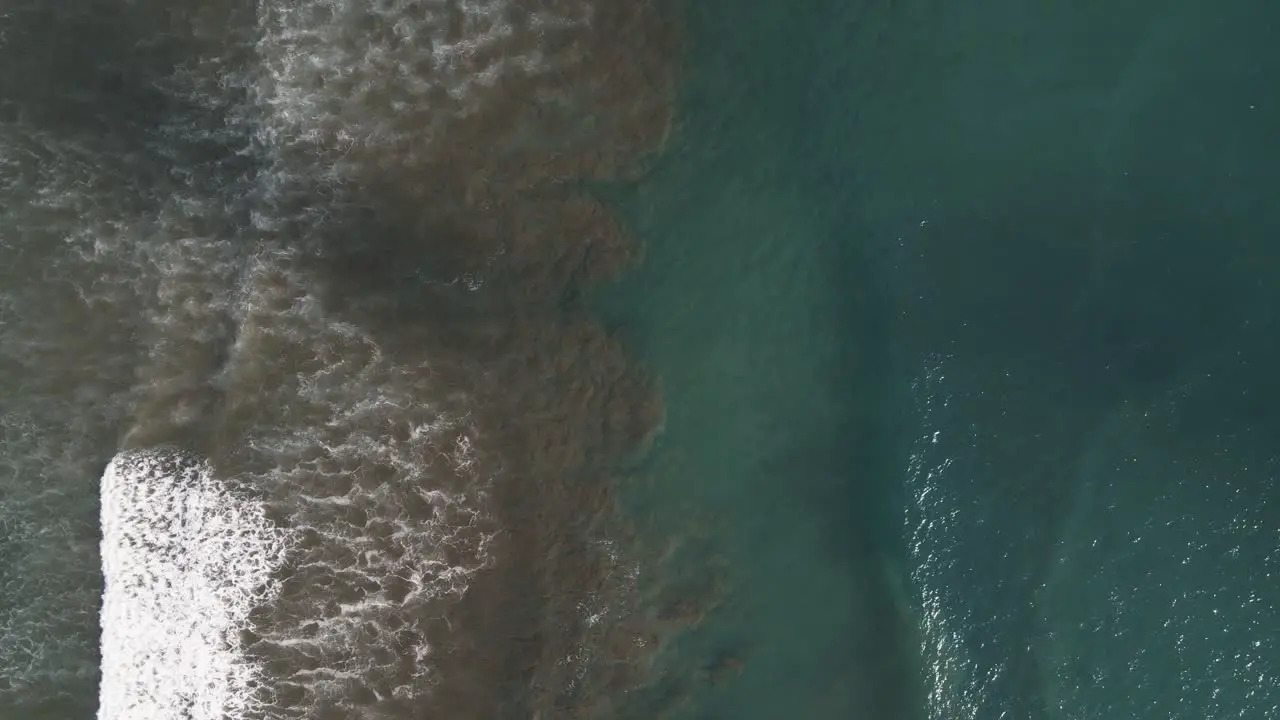 Aerial View Of Waves sitting the shore of Dominical Beach In Costa Rica Static Wide Shot