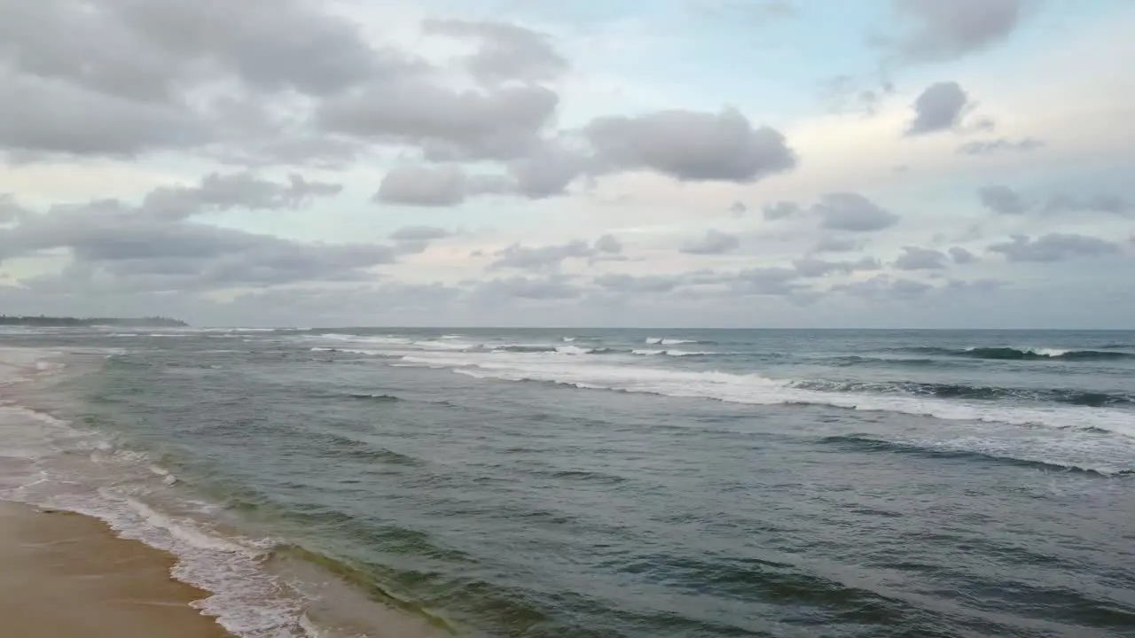 Ocean background bright blue sky with white clouds white sand beach and waves at open sea approaching horizon